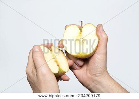 An Apple Fruit Cut In The Hand