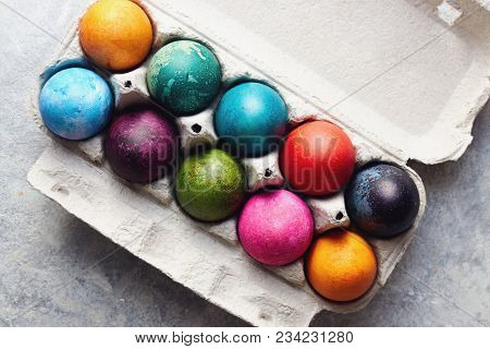 Colorful Easter eggs in egg box. Painted Easter eggs in an egg carton, close up.