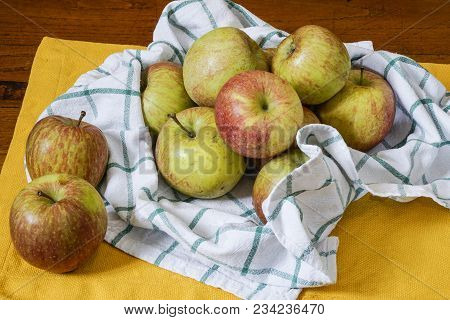 Some Apples On An Old Wooden Table