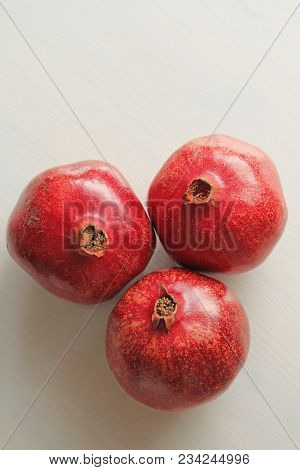 Big Ripe Red Granets Or Garnets. Fruits Of Red Ripe Pomegranate On The White Background. Vegetarian 