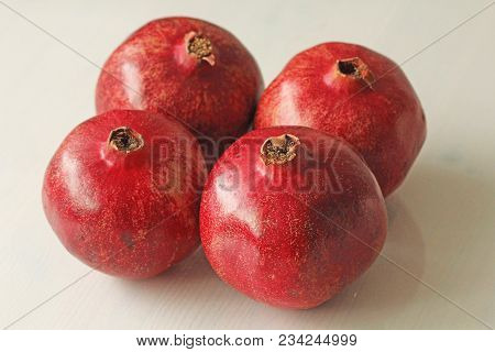 Big Ripe Red Granets Or Garnets. Fruits Of Red Ripe Pomegranate On The White Background. Vegetarian 