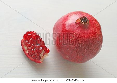 Big Ripe Red Granets Or Garnets. Fruits Of Red Ripe Pomegranate On The White Background. Vegetarian 