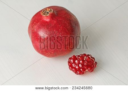 Big Ripe Red Granets Or Garnets. Fruits Of Red Ripe Pomegranate On The White Background. Vegetarian 