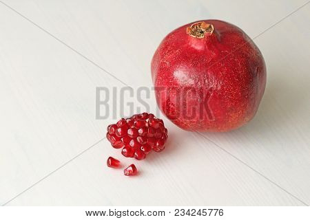 Big Ripe Red Granets Or Garnets. Fruits Of Red Ripe Pomegranate On The White Background. Vegetarian 