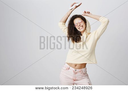 Woman Listening Her Favourite Song That Boost Her Mood. Studio Shot Of Positive Attractive European 