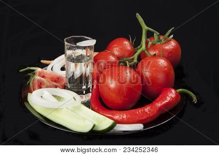 Still Life With Tomatoes And Cucumbers On A Dark Background
