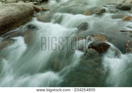 Beautiful Reshi River Water Flowing Through Stones And Rocks At Dawn, Sikkim, India. Reshi Is One Of