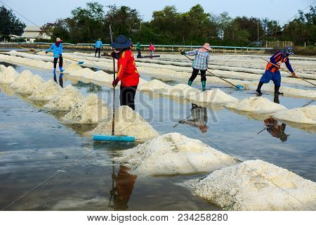 Phetchaburi, Thailand - April 29, 2012: Group Of Workers Making Heaps Of Salt In Salt Farm In Phetch