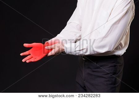 Pain In Hand, Joint Inflammation, Carpal Tunnel Syndrome, Studio Shot With Red Dot On Black Backgrou