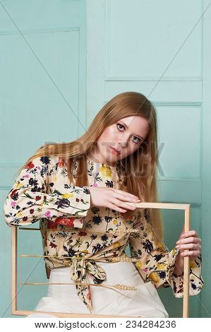 Girl With Long Hair, Long Sleeve Shirt With Floral Print And Wide White Pants. A Wistful Romantic Lo