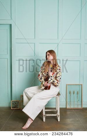 Girl With Long Hair, Long Sleeve Shirt With Floral Print And Wide White Pants. A Wistful Romantic Lo