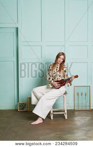 Girl With Long Hair, Long Sleeve Shirt With Floral Print And Wide White Pants. A Wistful Romantic Lo