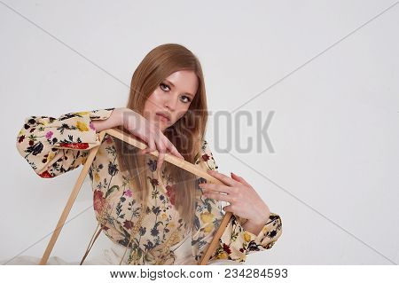 Girl With Long Hair, Long Sleeve Shirt With Floral Print And Wide White Pants. A Wistful Romantic Lo