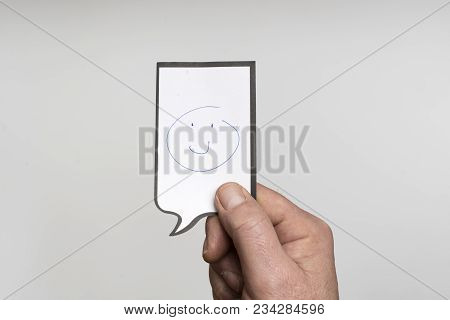 A Small Piece Of Paper With A Drawing Of A Smiling Face