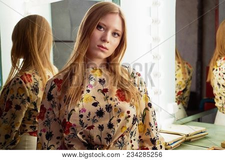 Girl With Long Hair, Long Sleeve Shirt With Floral Print And Wide White Pants. A Wistful Romantic Lo