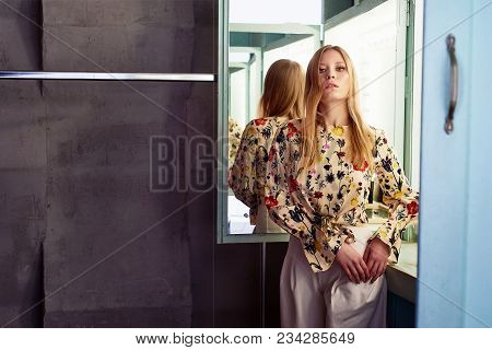 Girl With Long Hair, Long Sleeve Shirt With Floral Print And Wide White Pants. A Wistful Romantic Lo