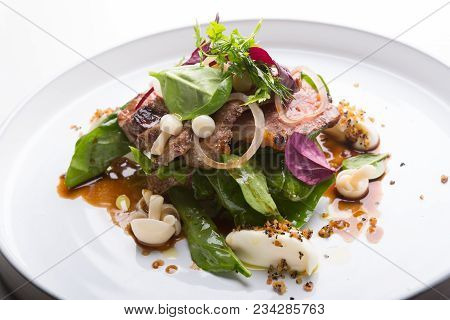 Prepared Roastbeef Served With Vegetables And Herbs On A Bread