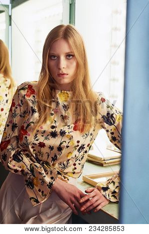 Girl With Long Hair, Long Sleeve Shirt With Floral Print And Wide White Pants. A Wistful Romantic Lo