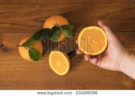 Make A Juice Of Oranges On A Wooden Table