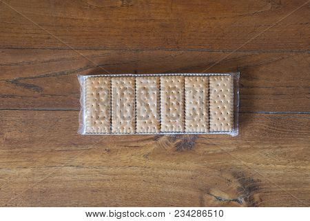 A Pack Of Cookies On The Wooden Table