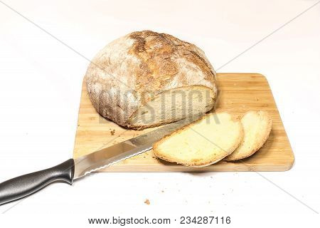 a loaf of sliced bread on a wooden cutting board