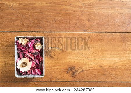 A Basket With Dried Flowers On The Wooden Floor
