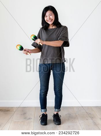 Asian ethnicity girl playing macaras