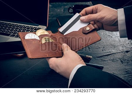 The Golden Bitcoin And Purse In Male Hands. Cryptocurrency Bitcoin Coins. Litecoin, Bitcoin, Ethereu