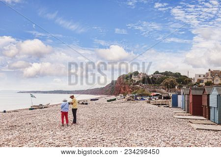 26 June 2017: Budleigh Salterton, East Devon, England, Uk - Senior Couple On The Pebble Beach At Bud