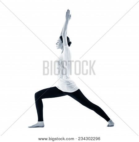 Young Woman Doing Yoga Exercise. In Warrior Possition. Isolated On White Background.