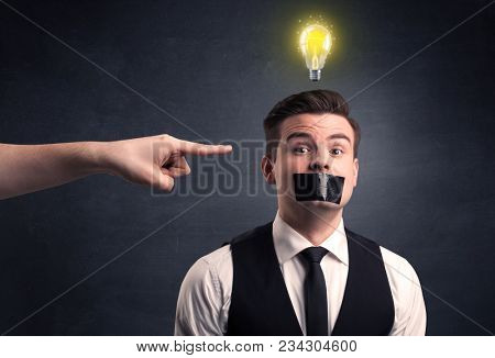 Caucasian hand pointing at businessman with a lightbulb above his head