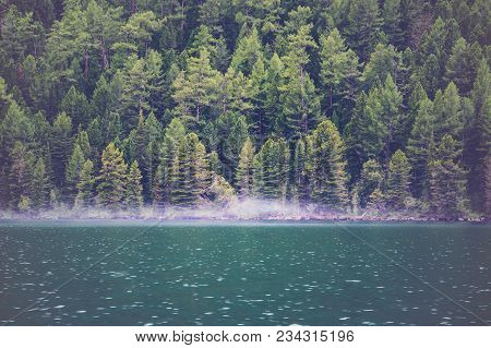 Smoke On The Water. View On Crystal Clear Lake With Mist And Reflection On The Water. Spruce Forest 