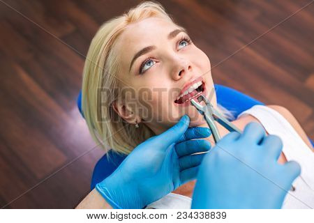 Woman Patient Sitting At Reception With Dentist And Hands With Tools.
