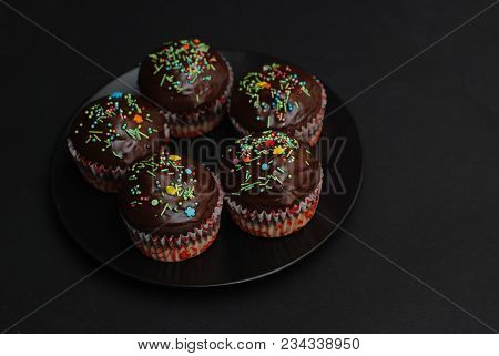 Homebaked Chocolate Muffins For Easter With Colored Conffeti. Dark Background. Sweet Dessert
