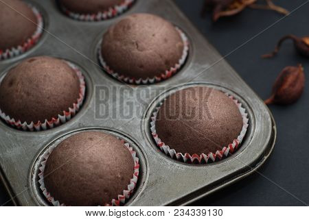 Just Baked Homebaked Chocolate Muffins For Dessert With Colored Conffeti.black Backgroun