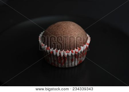 Just Baked Homebaked Chocolate Muffins For Dessert With Colored Conffeti. Black Background.