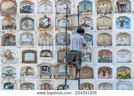 Ica, Peru - August 2017: A Keeper Is Taking Care Of The Above The Ground Tombs In The Ica Cemetery I
