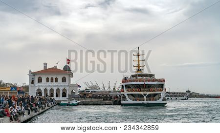 Istanbul, Turkey - April 2018: Traditional Istanbul Passenger Ferry Near The Pier On The Background 
