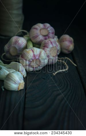 Garlic Heads On A Dark Wooden Table