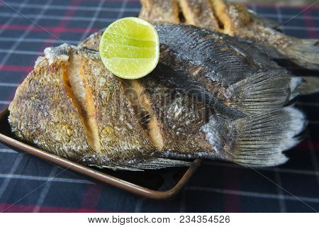 Fried Salted Dried Damsel Fish Servr With Lemon In Thai Style.