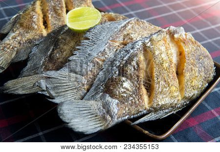 Fried Salted Dried Damsel Fish Servr With Lemon In Thai Style.