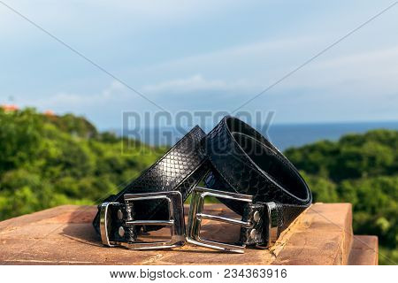 Fashion Luxury Snakeskin Leather Belts Outdoors. Python Belts On A Tropical Background. Indonesia, B
