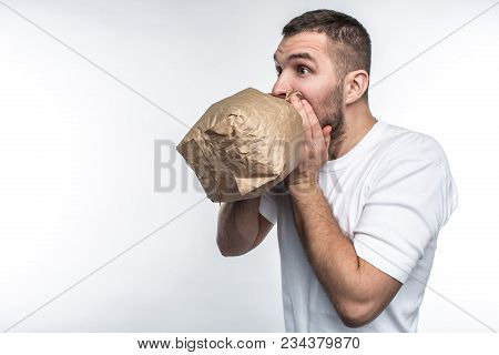 Man Suffering From A Stress Attack. He Is Trying To Come Calm Down. Isolated On White Background