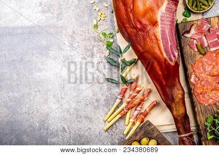 Appetizers Table With Spanish Iberian Whole Ham Jamon Serrano, Snacks, Olives And Red And Rose Wine.