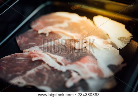 Beef Raw Meat Slides On Dish With Barbecue Sauce At Bbq. Yakiniku Grill Buffet Restaurant Japanese F