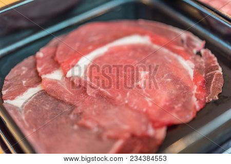 Beef Raw Meat Slides On Dish At Bbq. Restaurant