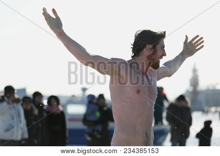 ST. PETERSBURG, RUSSIA - MARCH 4, 2018: Amateur winter swimmer at ice hole during Big Neva Cup. Winter swimmers from 12 countries aged from 12 to 78 take part in the competitions this year