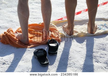 ST. PETERSBURG, RUSSIA - MARCH 4, 2018: Amateur winter swimmer at ice hole during Big Neva Cup. Winter swimmers from 12 countries aged from 12 to 78 take part in the competitions this year