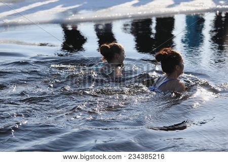 ST. PETERSBURG, RUSSIA - MARCH 4, 2018: Amateur winter swimmer at ice hole during Big Neva Cup. Winter swimmers from 12 countries aged from 12 to 78 take part in the competitions this year