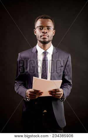 Close Up Shot Of Teacher Examiming His Students And Holding Empty Sheets Of Paper Isolated On The Bl
